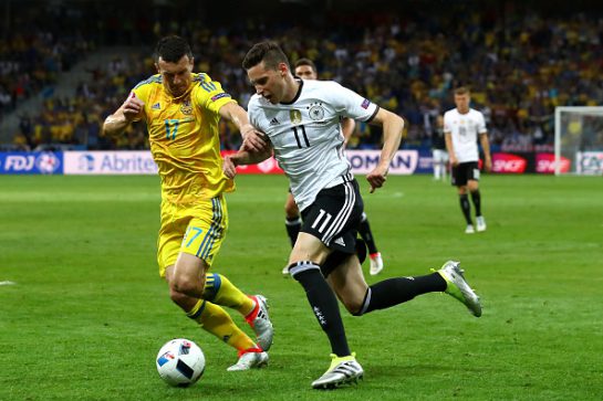 LILLE, FRANCE - JUNE 12:  Julian Draxler of Germany and Artem Fedetskiy of Ukraine compete for the ball during the UEFA EURO 2016 Group C match between Germany and Ukraine at Stade Pierre-Mauroy on June 12, 2016 in Lille, France.  (Photo by Alexander Hassenstein/Getty Images)